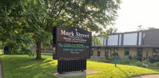 Toronto-based developer TVM Group is proposing a 17-storey residential-commercial development on this property, located just west of the Mark Street United Church building at 90 Hunter Street East in Peterborough's East City. Mark Street United Church has provided formal notice to the City of Peterborough of its intention to demolish the Christian Education Centre, pictured in the background in June 2024 when the developer held an open house for a 10-storey development. (Photo: Paul Rellinger / kawarthaNOW)