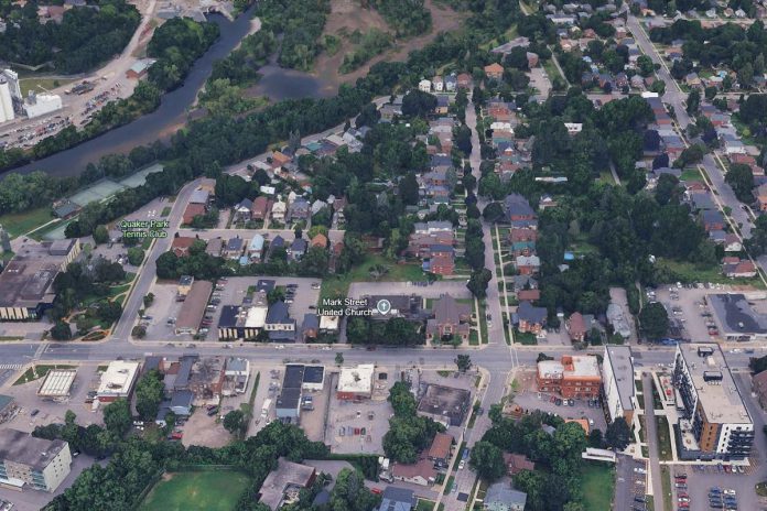 Mark Street United Church's Christian Education Centre, just beside the original church building in Peterborough's East City. This is the location for a proposed 17-storey high-rise, which would require the demolition of the church addition. For context, two six-storey buildings developed by Ashburnham Realty are pictured in the lower right of the image. (Photo: Google Earth)