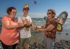 Monarch Teacher Network of Canada instructor Laurel Merriam, Friends of Presqu'ile Park member Don Davis, and "Monarch Butterfly Crusader" Carol Pasternak releasing tagged monarch butterflies at Presqu'ile Provincial Park in 2023. The Friends of Presqu'ile Park, a charitable organization devoted to preserving and protecting the natural heritage of Presqu'ile Provincial Park, invites the public to join park staff and volunteers on August 30 and 31, 2025 for the annual "Monarchs and Migrants Weekend" at the park in the Municipality of Brighton. (Photo: Jaime Rojo / National Geographic)
