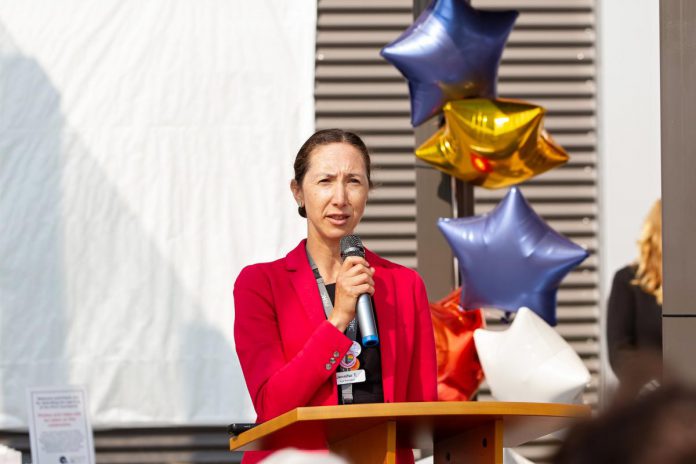 Jen Taylor, president of finance and corporate services and chief financial officer at Peterborough Regional Health Centre (PRHC), addresses the crowd during an event on August 6, 2025 to celebrate the opening of the donor-funded Psychiatric Intensive Care Unit (PICU) courtyard at the regional hospital. She said the space is a "game-changer" for patients in PRHC's six-bed PICU, who had previously never had access to the outdoors even though their stay could be weeks or even months long. (Photo: Jordan Lyall Photography for kawarthaNOW)