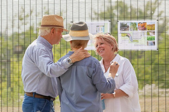 Kathryn Hildenbrand (right), gift processing and database officer for PRHC Foundation the Peterborough Regional Health Centre (PRHC) Foundation, speaks to two attendees during an event on August 6, 2025 to celebrate the opening of the donor-funded Psychiatric Intensive Care Unit (PICU) courtyard at the regional hospital. As with hospitals across the country, PRHC has seen an increase in patient volumes with over 31,000 mental health visits in 2024 alone. (Photo: Jordan Lyall Photography for kawarthaNOW)