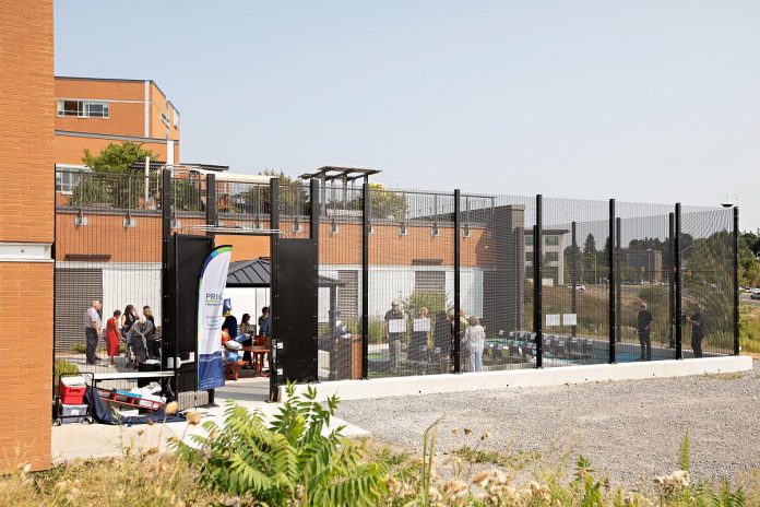 People gather to celebrate the new donor-funded Psychiatric Intensive Care Unit (PICU) courtyard at Peterborough Regional Health Centre (PRHC) on August 6, 2025. The $1.5 million purpose-built outdoor healing space will support the recovery and well-being of some of the hospital's most vulnerable mental health patients. The courtyard includes colourful native vegetation to attract butterflies, seating areas that offer patients solitude or space to connect with loved ones, an open gathering space for group activities and connection building, a shaded area to accommodate patients who are sunlight-sensitive due to their treatments, and a tactile recreation surface for yoga and other physical activities. (Photo: Jordan Lyall Photography for kawarthaNOW)