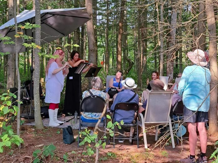 For the second year in a row, the Peterborough Symphony Orchestra is partnering with the Peterborough Field Naturalists to combine music and nature at Tecasy Ranch in Trent Hills in Peterborough County. On September 6, 2025, field guides will walk participants through an easy forested trail walk that will be interspersed with ensembles of music performances. Pictured are Jaye Marsh on flute and Jennifer Burford on violin during the inaugural event in 2024. (Photo courtesy of Peterborough Symphony Orchestra)