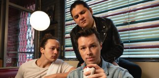 Vinnie Alberto as Nolan, Dillan Meighan Chiblow (standing) as Leon, and John Wamsley as Destin in the original musical Rez Gas, co-written by Alderville First Nation singer-songwriter Cale Crowe and Cobourg playwright and actor Genevieve Adam, which has its world premiere at the Capitol Theatre in Port Hope for 18 performances from August 22 to September 7, 2025. (Photo: Sam Moffatt)