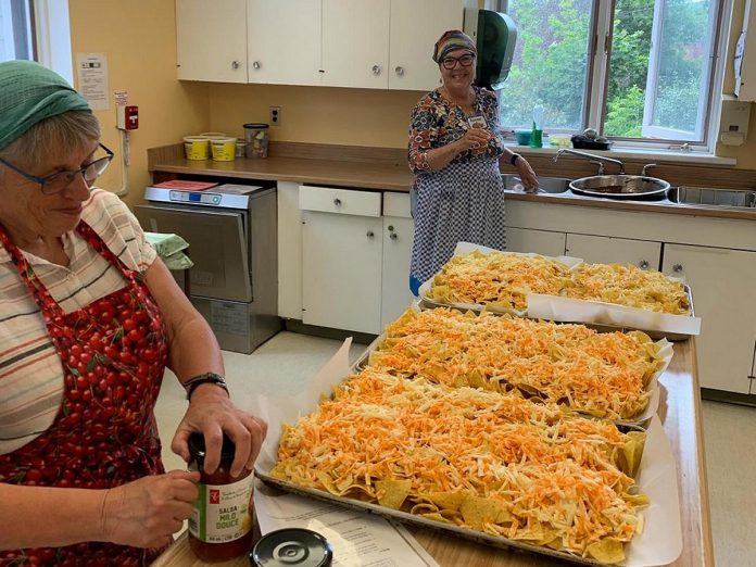 Volunteers Ellie and Renee help prepare food for students enrolled in the Upbeat! after-school program offered by the Kawartha Youth Orchestra, which not only promotes barrier-free musical education but encourages food literacy under the guidance of Lisa Dixon. (Photo: Lisa Dixon)