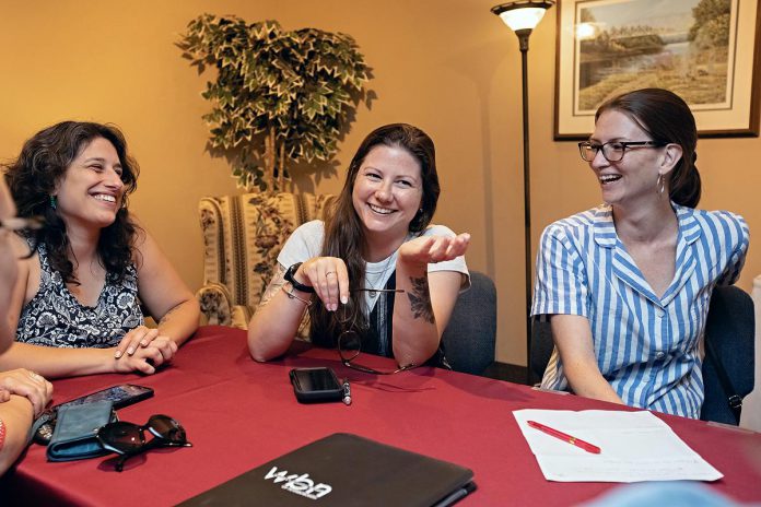 Women's Business Network of Peterborough (WBN) President Adeilah Dahlke, Past President Katelyn Kemp, and Tech Director Jessica Erickson connect during a board meeting ahead of the 2025-26 season, which kicks off with a speed networking event at Elmhirst's Resort in Keene on September 3, 2025. (Photo: Jordan Lyall Photography)