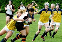 A group of young women playing rugby, with one woman being tackled. (Photo: Harry H Brewster vis Pexels)