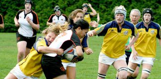 A group of young women playing rugby, with one woman being tackled. (Photo: Harry H Brewster vis Pexels)