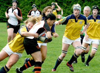 A group of young women playing rugby, with one woman being tackled. (Photo: Harry H Brewster vis Pexels)