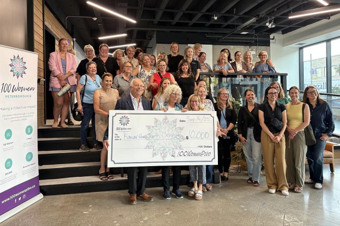 Kawartha Youth Orchestra volunteer John Good and board vice chair Joy Simmonds accept a $10,000 donation from 100 Women Peterborough founding member Wendy Hill as other members of the collective philanthropy group look on during the group's third meeting of 2025 in the lobby of the Venture North building on Tuesday, September 16. (Photo courtesy of 100 Women Peterborough)