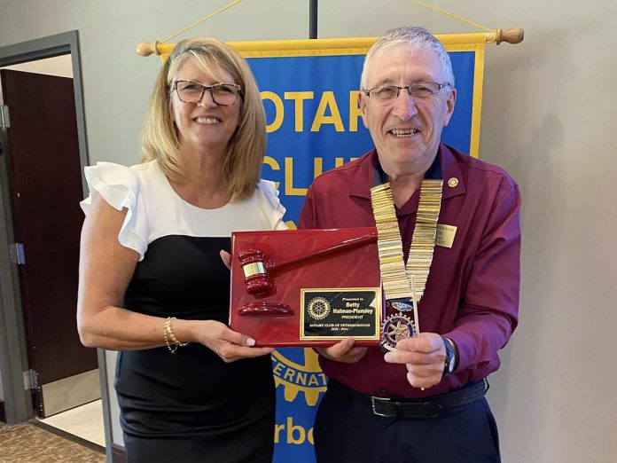 Betty Halman-Plumley receives a gavel plaque from then-incoming Rotary Club of Peterborough president Ken Seim in June 2024 at the Rotary Club of Peterborough changeover meeting. During her 2023-24 term as Rotary president, Halman-Plumley implemented a new three-year strategic plan, introduced a new major fundraiser, and oversaw the process for finding Rotary's next legacy project. (Photo courtesy of Rotary Club of Peterborough)