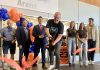 Grace Bowen's father Greg cuts the ribbon during a ceremony on September 14, 2025 at the Cobourg Community Centre to officially rename the Pond Arena as the Grace Bowen Arena, as actor Ryan Reynolds (far right) stands beside Grace's mother Andrea and sister Mackenzie. In April, Reynolds appeared before a committee of Cobourg council on behalf of the Bowen family to request the arena be renamed in memory of the nine-year-old Grafton hockey player who passed away from an aggressive form of bone cancer in 2015. (Photo: Natalie Hamilton / kawarthaNOW)