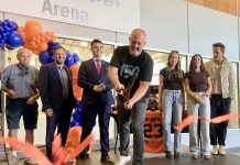 Grace Bowen's father Greg cuts the ribbon during a ceremony on September 14, 2025 at the Cobourg Community Centre to officially rename the Pond Arena as the Grace Bowen Arena, as actor Ryan Reynolds (far right) stands beside Grace's mother Andrea and sister Mackenzie. In April, Reynolds appeared before a committee of Cobourg council on behalf of the Bowen family to request the arena be renamed in memory of the nine-year-old Grafton hockey player who passed away from an aggressive form of bone cancer in 2015. (Photo: Natalie Hamilton / kawarthaNOW)