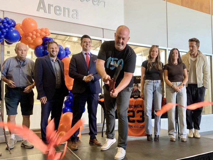 Grace Bowen's father Greg cuts the ribbon during a ceremony on September 14, 2025 at the Cobourg Community Centre to officially rename the Pond Arena as the Grace Bowen Arena, as actor Ryan Reynolds (far right) stands beside Grace's mother Andrea and sister Mackenzie. In April, Reynolds appeared before a committee of Cobourg council on behalf of the Bowen family to request the arena be renamed in memory of the nine-year-old Grafton hockey player who passed away from an aggressive form of bone cancer in 2015. (Photo: Natalie Hamilton / kawarthaNOW) Grace Bowen's father Greg cuts the ribbon during a ceremony on September 14, 2025 at the Cobourg Community Centre to officially rename the Pond Arena as the Grace Bowen Arena, as actor Ryan Reynolds (far right) stands beside Grace's mother Andrea and sister Mackenzie. In April, Reynolds appeared before a committee of Cobourg council on behalf of the Bowen family to request the arena be renamed in memory of the nine-year-old Grafton hockey player who passed away from an aggressive form of bone cancer in 2015. (Photo: Natalie Hamilton / kawarthaNOW)