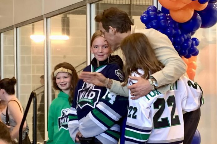 Actor Ryan Reynolds with some of Grace Bowen's teammates who played a scrimmage game at the Cobourg Community Centre following a ceremony on September 14, 2025 to officially rename the Pond Arena as the Grace Bowen Arena. Grace played with the West Northumberland Girls Hockey Association before she passed away in 2015 at the age of nine from an aggressive form of bone cancer. (Photo: Natalie Hamilton / kawarthaNOW)