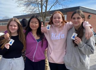 Students from Queen Mary Public School show off their transit passes for Grade 8 Transit Quest, a transit encouragement campaign organized by Active School Travel Peterborough. Transit ridership in youth is important for building life skills, accessing extracurricular opportunities, and fostering independence. (Photo: Natalie Stephenson / GreenUP)
