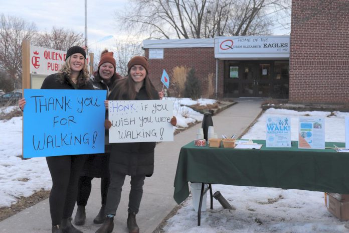 GreenUP active transportation placement student Sara Burns, active transportation program coordinator Ashley Burnie Seeds, and teacher Brianna Elliot pose outside Queen Elizabeth Public School during a Winter Walk Day celebration. At the event, students posed for pictures in a photo booth, drank hot apple cider, and listened to music in the snowy school yard. Seasonal events are a great way to encourage community and excitement about school travel. (Photo: Jessica Todd / GreenUP)