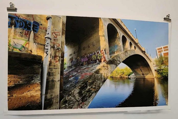 A one-of-a-kind massive print of the Hunter Street Bridge, which connects Peterborough's downtown to East City, is one of several items up in the "Keys To Hope" fundraising auction. Proceeds from the auction will support the Habitat for Humanity Peterborough & Kawarthas Region build in collaboration with Our Daughters' Home that will provide a safe, permanent home for seven women living with developmental disabilities on Sophia Street in East City. Open to community members to donate items as well as to bid, the online auction is running now until midnight on October 10, 2025. (Photo courtesy of Ashley Bonner) A one-of-a-kind massive print of the Hunter Street Bridge, which connects Peterborough's downtown to East City, is one of several items up in the "Keys To Hope" fundraising auction. Proceeds from the auction will support the Habitat for Humanity Peterborough & Kawarthas Region build in collaboration with Our Daughters' Home that will provide a safe, permanent home for seven women living with developmental disabilities on Sophia Street in East City. Open to community members to donate items as well as to bid, the online auction is running now until midnight on October 10, 2025. (Photo courtesy of Ashley Bonner)