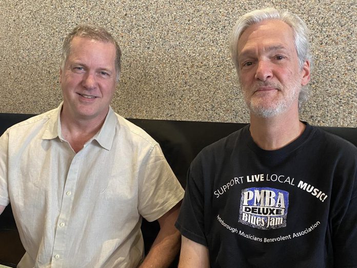 With the help of local musician and producer John Crown (left), longtime Peterborough singer-songwriter Mark Beatty (right) has released his debut album "Audiodacity" at the age of 65, recording 12 original songs from among the 3,000-plus he has written during his career. Two of the songs on the album were produced and mixed by Peterborough native and LA-based Grammy award-winning producer Greg Wells, with the remaining songs produced and mixed by Crown and James McKenty. (Photo: Paul Rellinger / kawarthaNOW)