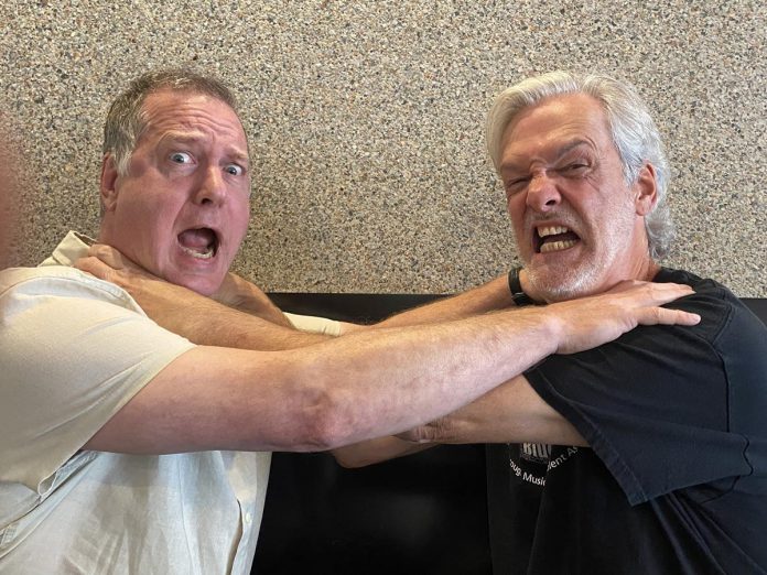 Local musician and producer John Crown and Peterborough singer-songwriter Mark Beatty ham it up during a chat about Beatty's debut album "Audiodacity." Despite setbacks and creative disagreements over the past two years while the album was being arranged, produced, and mixed, they remain friends. (Photo: Paul Rellinger / kawarthaNOW)