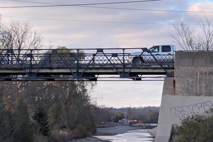 A pickup truck crosses the single-lane bridge on McFarlane Street via Ashburnham Drive on October 31, 2020. (Photo: Bruce Head / kawarthaNOW)