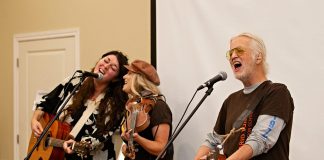 Terra Lightfoot and Melissa Payne join Blue Rodeo's Greg Keelor during a performance at "Raise a Little Shell" at the Ontario Turtle Conservation Centre (OTCC) on September 4, 2025. Emceed by Greg's wife Caolaidhe, a volunteer at OTCC who helped organize the event with the aim of raising awareness of the plight of Ontario's eight native turtle species and the work of the OTCC, the event also included a presentation from OTTC education coordinator Lisa Browning and from Ontario Nature's conservation policy and campaigns director Tony Morris. (Photo: Jordan Lyall Photography for kawarthaNOW)