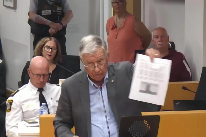 "When I look at this rendering ... it appears to me that the proponents of this development and seven members of this council are giving my community the finger, because that's exactly what that reminds me of," said East City resident and former Peterborough mayor Paul Ayotte during a council meeting on September 3, 2025 where council voted 7-4 to approve a zoning by-law amendment that allows a 17-storey high-rise to be built in downtown East City. (kawarthaNOW screenshot of City of Peterborough video)