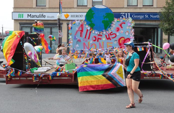 A float during the Peterborough-Nogojiwanong Pride Parade on September 27, 2025 includes the Pride Week theme of "All of Us or None," which reflects the challenges facing the global 2SLGBTQIA+ community with the rise of anti-trans legislation, the banning of 2SLGBTQIA+ books in schools and libraries, and the withdrawal of public support by some organizations and businesses for progressive causes. (Photo courtesy of Sean Bruce)