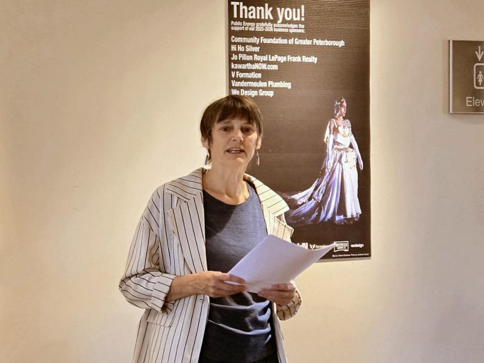 Kate Alton, programming director of Public Energy Performing Arts in Peterborough, speaks about the 2025-26 season lineup for the contemporary performance arts presenter at Market Hall Performing Arts Centre in downtown Peterborough on September 16, 2025, with a poster of Public Energy's 2025-26 sponsors in the background. An award-winning dancer, choreographer, and multi-disciplinary theatre creator, Alton assumed responsibility for programming for Public Energy following founder Bill Kimball's retirement last season. (Photo: Jeannine Taylor / kawarthaNOW)