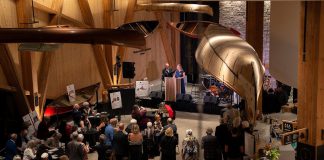 Guests at the Lakeside Gala at The Canadian Canoe Museum in Peterborough on October 4, 2025 listen to a speech by the museum's executive director Carolyn Hyslop and curator Jeremy Ward in the museum's atrium during the inaugural event that raised $150,000 in support of the not-for-profit museum and its programming. (Photo courtesy of The Canadian Canoe Museum)