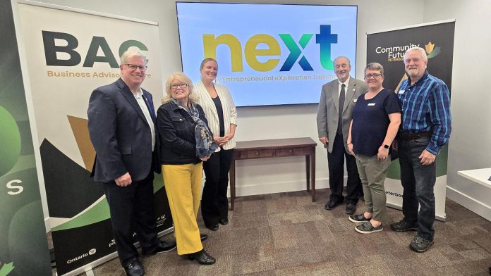 Community Futures Peterborough (CFP) board chair Wayne Harding, Peterborough County warden Bonnie Clark, CFP executive director Devon Girard, CFP board secretary Ron Black, Peterborough and the Kawarthas Chamber of Commerce president and CEO Brenda Whitehead, and CFP board member Rod Wallace at the announcement of the New Entrepreneurial eXploration Training (NEXT) program on October 29, 2025 at Venture North in downtown Peterborough. (Photo: Jeannine Taylor / kawarthaNOW)