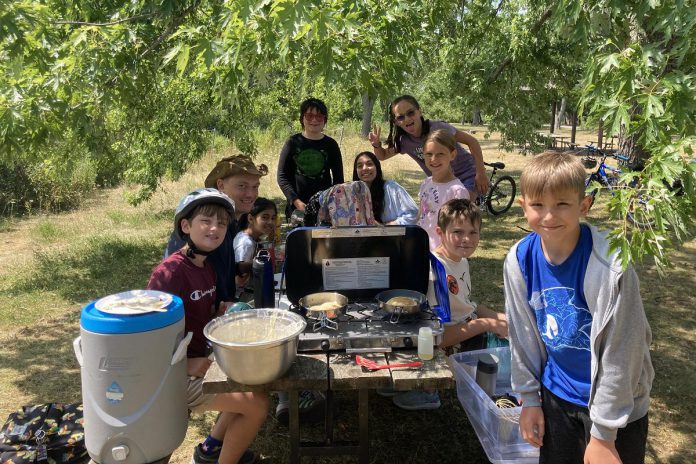 GreenUP Urban Bike Adventure campers taking a pancake break earlier this summer. Urban Bike Adventures Camp is one of the many ways Peterborough GreenUP engages community in the climate conversation. Fostering education and a sense of shared purpose between community members strengthens its resilience as a whole. (Photo: Liam Seaker / GreenUP)