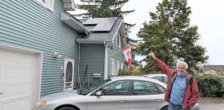 Lakefield resident Guy Hanchet proudly displays his newly installed solar panels. Despite not having an ideal rooftop for solar, he expects to power about half of his annual electricity use from the system. (Photo: Clara Blakelock / GreenUP)