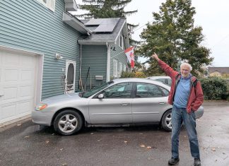 Lakefield resident Guy Hanchet proudly displays his newly installed solar panels. Despite not having an ideal rooftop for solar, he expects to power about half of his annual electricity use from the system. (Photo: Clara Blakelock / GreenUP)