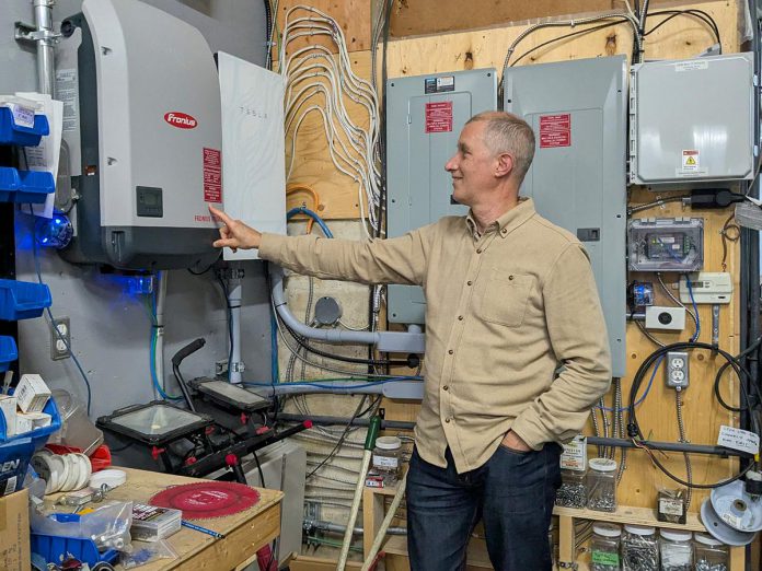 Generation Solar co-owner and vice-president JP Pawliw displays a battery in the office that is connected to a rooftop solar system. If weather permits, this battery can recharge using the panels, extending its life during power outages. (Photo: Clara Blakelock / GreenUP)