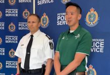 Trent University's associate vice president of students Lawrence Lam speaks as Peterborough police staff sergeant Mark Reesor looks on during a media conference on October 3, 2025 about police preparations for Trent University's 54th annual Head of the Trent weekend. (kawarthaNOW screenshot of Peterborough Police Service video)