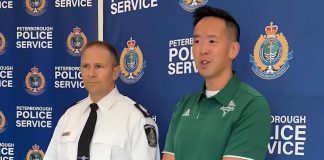 Trent University's associate vice president of students Lawrence Lam speaks as Peterborough police staff sergeant Mark Reesor looks on during a media conference on October 3, 2025 about police preparations for Trent University's 54th annual Head of the Trent weekend. (kawarthaNOW screenshot of Peterborough Police Service video)