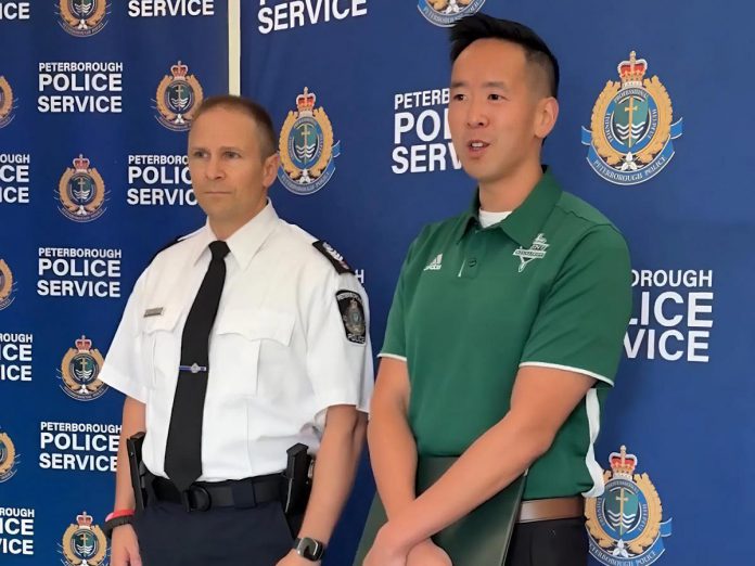 Trent University's associate vice president of students Lawrence Lam speaks as Peterborough police staff sergeant Mark Reesor looks on during a media conference on October 3, 2025 about police preparations for Trent University's 54th annual Head of the Trent weekend. (kawarthaNOW screenshot of Peterborough Police Service video)