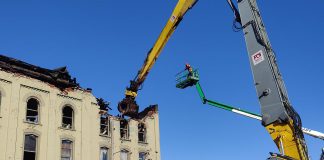 A grapple removes debris from the fire-devastated Kawartha Home Hardware building in downtown Lakefield on October 12, 2025 as a Priestly Demolition Inc. employee supervises from a boom truck. (Photo: Scott Norwood)