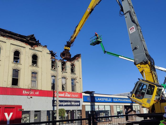 A grapple removes debris from the fire-devastated Kawartha Home Hardware building in downtown Lakefield on October 12, 2025 as a Priestly Demolition Inc. employee supervises from a boom truck. (Photo: Scott Norwood)