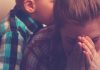 Peterborough parents feel isolated and overwhelmed, according to new research report A women covers her face with her hands with a young boy in the background. (Stock photo)
