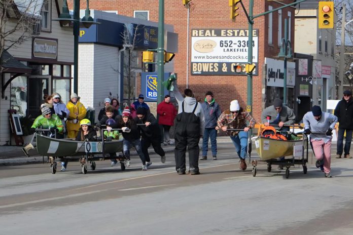 Racing canoes down Queen Street in Lakefield is just one of the many family-friendly activities during PolarFest, an annual township-wide winter festival. The event also features ice carvings, hockey games, a polar plunge for charity, fireworks, the Lakefield Chocolate Creations Festival, and more. (Photo: Selwyn Township)