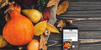 A smartphone sitting on a harvest table covered with squash and fall leaves displaying kawarthaNOW's Thanksgiving Monday 2025 holiday hours story. (kawarthaNOW photo)