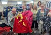 United Way Peterborough & District CEO Jim Russell and Bev Assinck of Peterborough Action for Tiny Homes (PATH) hold up clothing on October 8, 2025 during the launch of the annual Coats for Community campaign at PATH's location at 385 Lansdowne Street East in Peterborough. (Photo: United Way Peterborough & District)