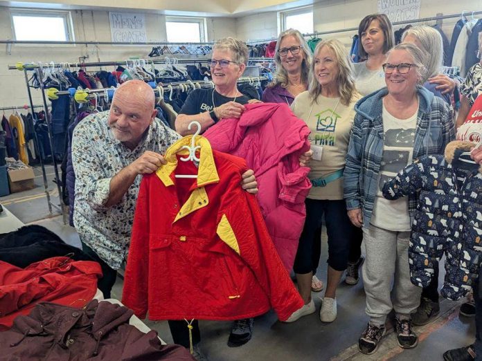 United Way Peterborough & District CEO Jim Russell and Bev Assinck of Peterborough Action for Tiny Homes (PATH) hold up clothing on October 8, 2025 during the launch of the annual Coats for Community campaign at PATH's location at 385 Lansdowne Street East in Peterborough. (Photo: United Way Peterborough & District) United Way Peterborough & District CEO Jim Russell and Bev Assinck of Peterborough Action for Tiny Homes (PATH) hold up clothing on October 8, 2025 during the launch of the annual Coats for Community campaign at PATH's location at 385 Lansdowne Street East in Peterborough. (Photo: United Way Peterborough & District)