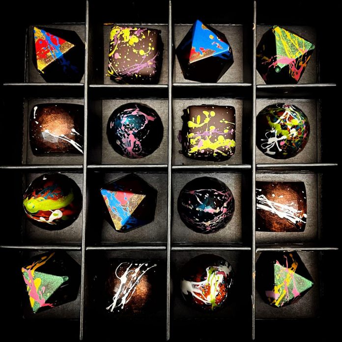 Through her products at Centre & Main Chocolate Co. like these caramel and ganache-filled bonbons, award-winning chocolatier Angela Roech aims to craft chocolates that are as visually appealing as they are delicious, saying "you eat first with your eyes." (Photo courtesy of Centre & Main Chocolate Co.)