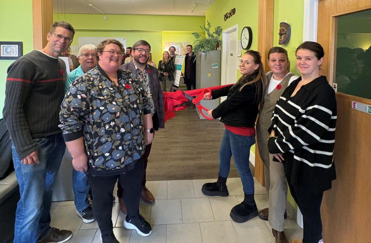 Point in Time executive director Marg Cox (second from left) and Canadian Mental Health Association Haliburton, Kawartha, Pine Ridge (CMHA HKPR) program supervisor David Bradley (fourth from left) along with peer specialists cut the ribbon for "Coming Full Circle" at 83 Maple Avenue in Haliburton on November 4, 2025. Funded by Health Canada, the two-year initiative is designed to help people with mental health and addiction challenges succeed by building a network of trained and mentored workers who have lived experience. (Photo: CMHA HKPR)