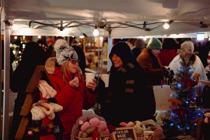 The Neighbourhood Vintage and First Friday Peterborough are teaming up once again to host the fourth annual Holiday Night Market, held in the Bankers Commons Courtyard off Water Street in downtown Peterborough on December 5, 2025. The outdoor market will feature 24 local artisans and makers selling art and homemade goods, as well as live music from five local musicians, and holiday treats and drinks from five downtown restaurants. (Photo: Luke Best) The Neighbourhood Vintage and First Friday Peterborough are teaming up once again to host the fourth annual Holiday Night Market, held in the Bankers Commons Courtyard off Water Street in downtown Peterborough on December 5, 2025. The outdoor market will feature 24 local artisans and makers selling art and homemade goods, as well as live music from five local musicians, and holiday treats and drinks from five downtown restaurants. (Photo: Luke Best)