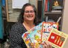Speech-language pathologist Ida Lloyd at Five Counties Children's Centre displays a few of the books that clinicians at the regional treatment centre recommend parents and caregivers put under the tree for children this holiday season. (Photo: Five Counties Children's Centre)