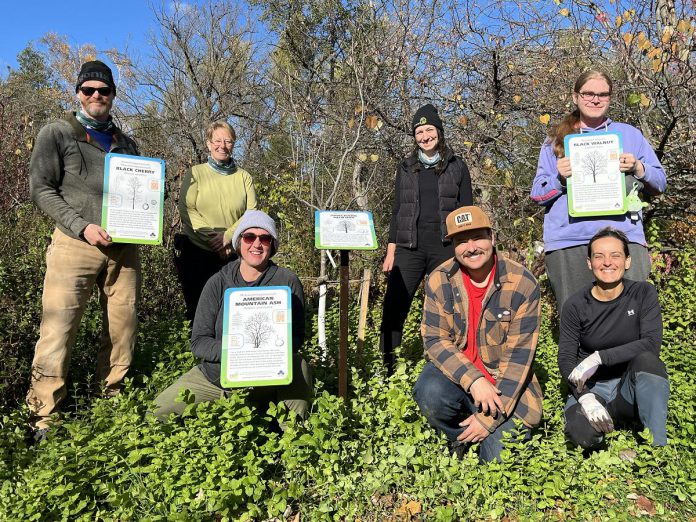 In October 2025, staff and volunteers planted 125 new native trees in GreenUP Ecology Park. Some of the group is pictured here in the park alongside a handful of new educational signs associated with select species in the park. (Photo: Yvonne Hollandy / GreenUP)